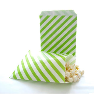 Green and white striped paper bags with popcorn on a white background